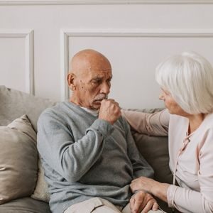 Persistently dry or mildly mucus productive cough